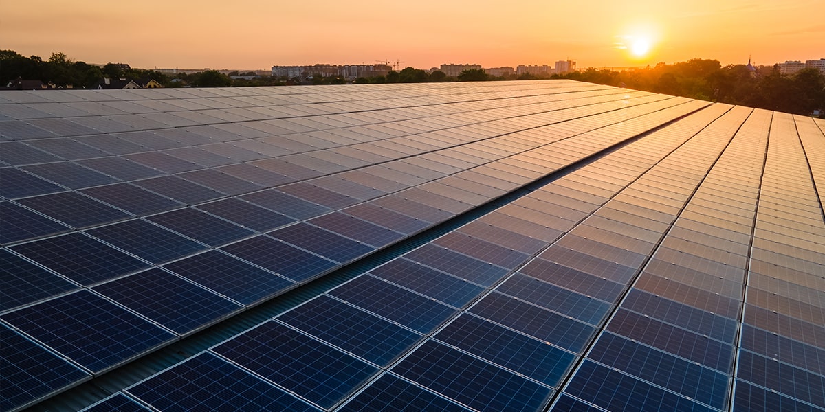 commercial solar panels on roof in sunset