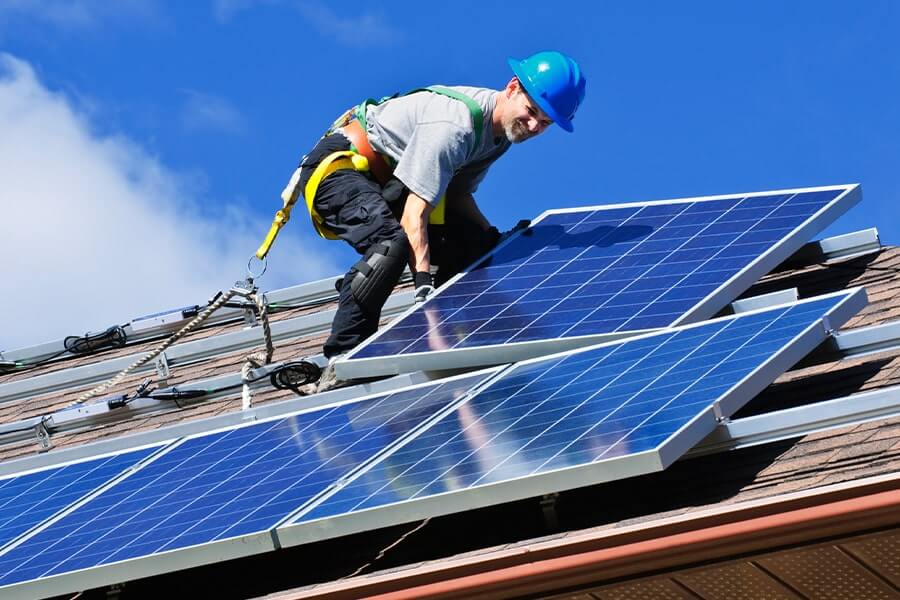 Solar Panel Installer with Blue Sky